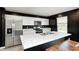 Modern kitchen featuring white cabinets, stainless steel appliances, and a white countertop island at 6332 Card Blvd, Indianapolis, IN 46221