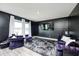 Modern living room with dark accent wall, plush purple seating, and abundant natural light at 6332 Card Blvd, Indianapolis, IN 46221
