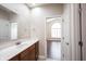 Bathroom with a vanity, sink, mirror and access to a room with a large arched window at 6586 Quail Run, Fishers, IN 46038