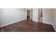 Bedroom with a walk-in closet and ensuite bathroom, featuring modern hardwood floors at 6586 Quail Run, Fishers, IN 46038