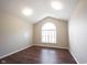 Bedroom with vaulted ceiling and large window, showcasing modern hardwood floors at 6586 Quail Run, Fishers, IN 46038