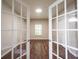 Bedroom view through glass doors, showcasing wood floors and ample natural light at 6586 Quail Run, Fishers, IN 46038