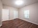 Bedroom with wood floors, a window for natural light, and closet for storage at 6586 Quail Run, Fishers, IN 46038