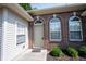 Charming brick entryway with decorative arched windows and a beige front door at 6586 Quail Run, Fishers, IN 46038