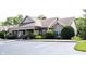 Charming one-story brick clubhouse with beautiful stone accents, manicured landscaping, and ample parking at 6586 Quail Run, Fishers, IN 46038