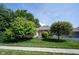 Well-manicured lawn with mature trees in the front yard at 6586 Quail Run, Fishers, IN 46038