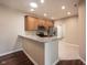 Open-concept kitchen featuring stainless appliances, granite countertops, and tile floors at 6586 Quail Run, Fishers, IN 46038