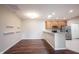 Well-lit open kitchen featuring stainless appliances, granite countertops and breakfast bar at 6586 Quail Run, Fishers, IN 46038