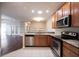 Bright kitchen with stainless steel appliances, granite countertops, and adjacent living area at 6586 Quail Run, Fishers, IN 46038