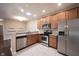 Well-lit kitchen featuring stainless steel appliances, granite countertops, and light wood cabinetry at 6586 Quail Run, Fishers, IN 46038