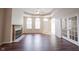 Spacious living room featuring a fireplace, large windows, and french doors at 6586 Quail Run, Fishers, IN 46038