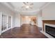 Living room featuring a fireplace and hardwood floors, opening into the kitchen at 6586 Quail Run, Fishers, IN 46038