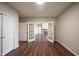 Spacious room with wood floors, fireplace, and french doors to another room at 6586 Quail Run, Fishers, IN 46038