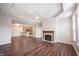 Open living area featuring a fireplace, hardwood floors, and a view of the kitchen at 6586 Quail Run, Fishers, IN 46038