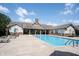 Large outdoor pool surrounded by ample seating and a well-maintained deck, perfect for relaxation and recreation at 6586 Quail Run, Fishers, IN 46038