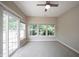 Bright sun room with tiled flooring, ceiling fan, and sliding glass door to patio at 6586 Quail Run, Fishers, IN 46038