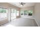 Sun room with a ceiling fan, tiled floors, and large windows for natural light at 6586 Quail Run, Fishers, IN 46038