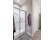 Bathroom featuring glass shower doors, a gray rug, and neutral paint at 6737 Trey Dr, Camby, IN 46113