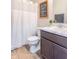 Neutral toned bathroom featuring a shower with curtain, a single sink vanity, and framed art at 6737 Trey Dr, Camby, IN 46113