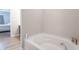 A bathroom featuring a white tub with an accent bottle and nautical themed decor at 6737 Trey Dr, Camby, IN 46113