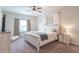 A bedroom features a bed with a white wooden frame, neutral walls, and a ceiling fan at 6737 Trey Dr, Camby, IN 46113