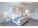 Bedroom featuring a bed with a white wooden frame, neutral walls, ceiling fan and attached bath at 6737 Trey Dr, Camby, IN 46113