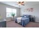 Cozy bedroom with a ceiling fan, natural light, and a comfortable blue quilted bedspread at 6737 Trey Dr, Camby, IN 46113