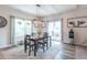 Cozy dining area featuring a modern light fixture, neutral colored walls, and a view of the backyard at 6737 Trey Dr, Camby, IN 46113