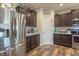 A kitchen featuring stainless steel appliances, brown cabinets, and a marble countertop at 6737 Trey Dr, Camby, IN 46113