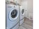 Laundry room featuring white appliances, and light wood-look flooring at 6737 Trey Dr, Camby, IN 46113