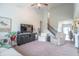 Open-concept living room with comfortable seating, high ceilings, and a ceiling fan at 6737 Trey Dr, Camby, IN 46113