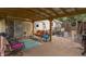 Back patio with a covered seating area, porch swing, basketball hoop and fenced in yard at 6805 Jackson St, Indianapolis, IN 46241