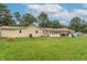 The backyard features a spacious lawn, covered patio, and plenty of space for outdoor activities at 6805 Jackson St, Indianapolis, IN 46241
