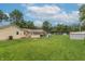 The backyard has a sprawling lawn with a partially covered patio and plenty of space for outdoor activities at 6805 Jackson St, Indianapolis, IN 46241