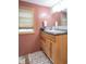 Bathroom featuring a wooden vanity with granite countertops, a window, and neutral color palette at 6805 Jackson St, Indianapolis, IN 46241