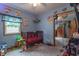 This is a cute bedroom featuring a crib, carpet flooring and natural light at 6805 Jackson St, Indianapolis, IN 46241