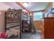 A room has a grey bunk bed with colorful décor and a window letting in natural light at 6805 Jackson St, Indianapolis, IN 46241
