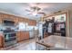 Charming kitchen features wood cabinets, stainless steel appliances, and laminate flooring at 6805 Jackson St, Indianapolis, IN 46241