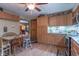 The kitchen features wood cabinets, updated appliances, and a cozy eating area at 6805 Jackson St, Indianapolis, IN 46241