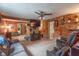 The spacious living room showcases wood paneled walls, multiple doorways, and an inviting entertainment area at 6805 Jackson St, Indianapolis, IN 46241