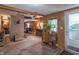 Inviting living area featuring wood-paneled walls, tile, and carpet flooring with natural light at 6805 Jackson St, Indianapolis, IN 46241