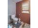 The toilet is a standard white model and the bathroom has neutral color scheme at 6805 Jackson St, Indianapolis, IN 46241