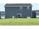 Large backyard with outdoor seating area and sliding glass doors at 7153 Sultans Run Ln, Whitestown, IN 46075