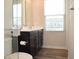 Bathroom featuring a double sink vanity, dark cabinetry and a full mirror offering both style and function at 7153 Sultans Run Ln, Whitestown, IN 46075