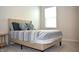 Cozy bedroom with a bed, blue pillows, striped bedding, and a window for natural light at 7153 Sultans Run Ln, Whitestown, IN 46075