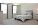 Spacious bedroom with cozy bedding, two windows offering natural light and neutral-toned walls at 7153 Sultans Run Ln, Whitestown, IN 46075