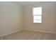 Bedroom with neutral carpet, white walls, and a window with a serene view at 7153 Sultans Run Ln, Whitestown, IN 46075