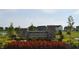 Landscaped entrance to Jackson Run community with stone signage and colorful flower beds at 7153 Sultans Run Ln, Whitestown, IN 46075
