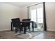 Contemporary dining room with a sleek black table, comfortable upholstered chairs, and sliding doors to the outdoors at 7153 Sultans Run Ln, Whitestown, IN 46075