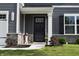 Welcoming front entrance with black door, sidelights, and decorative stone accents at 7153 Sultans Run Ln, Whitestown, IN 46075